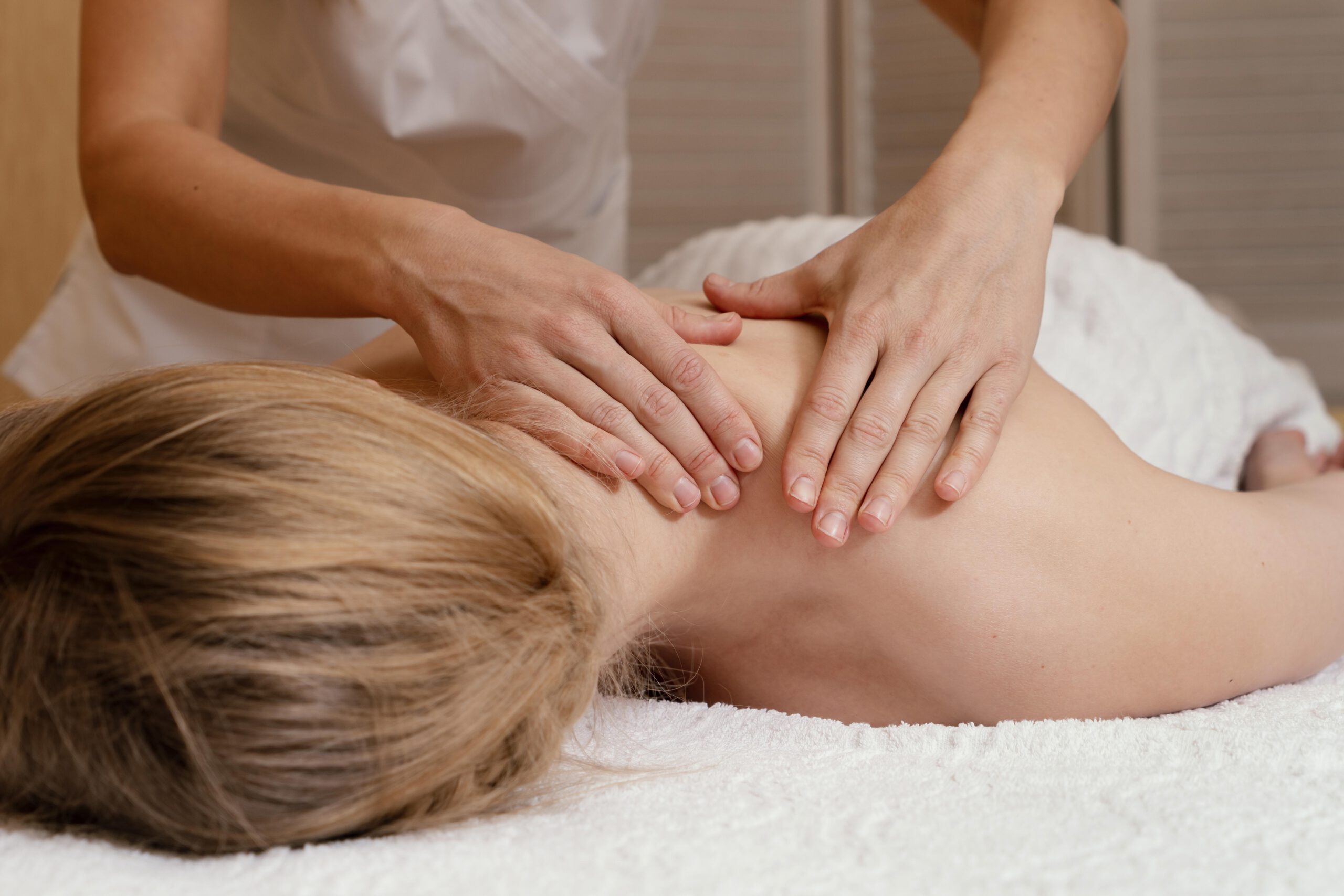 close-up-hands-massaging-woman-s-back