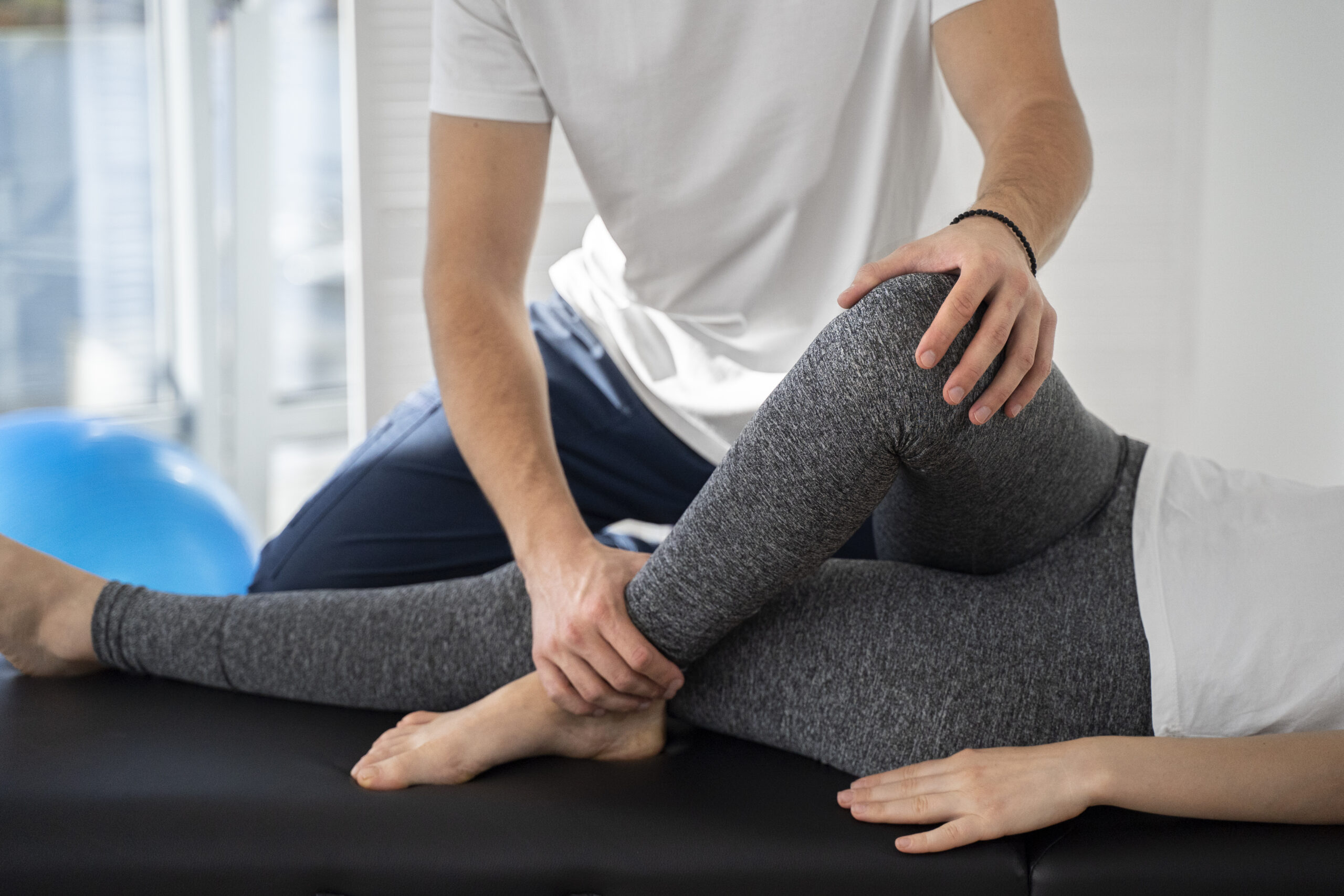 physiotherapist-helping-patient-s-leg-close-up